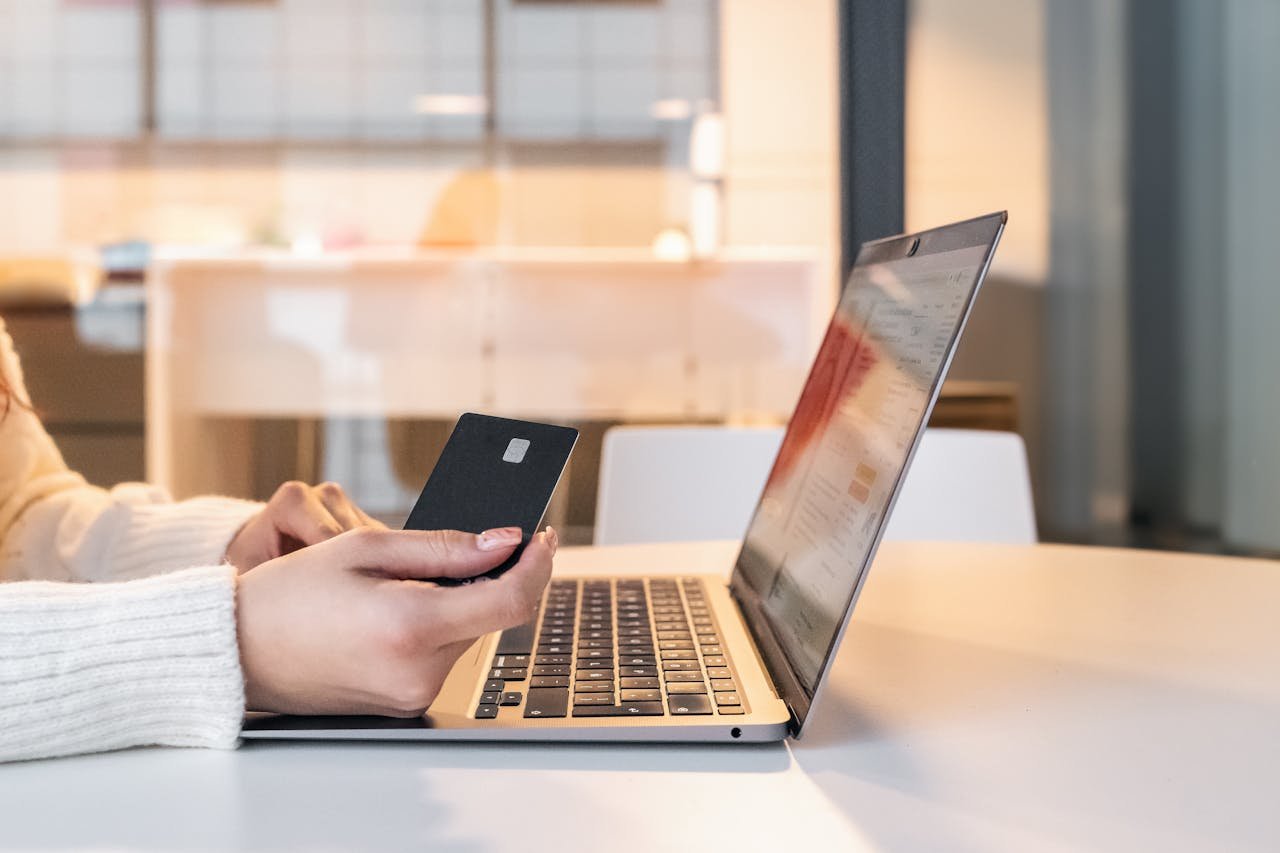 Woman with credit card and laptop